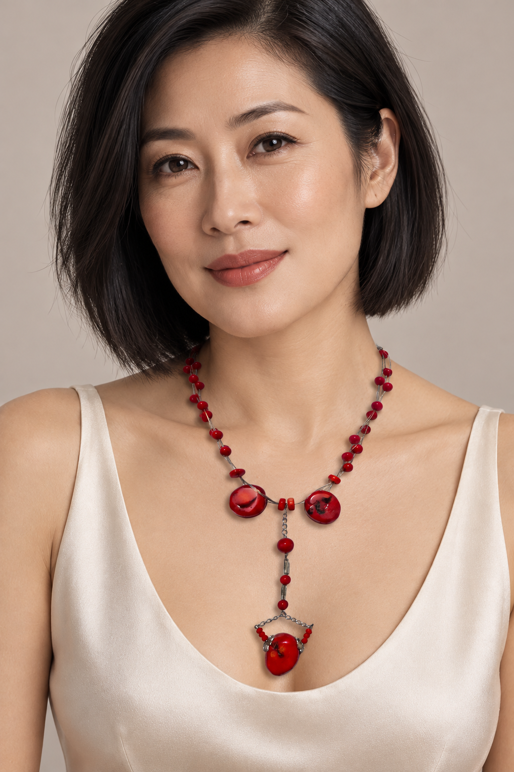AI generated model wearing D’or RON 434 red dyed bamboo coral lariat necklace.